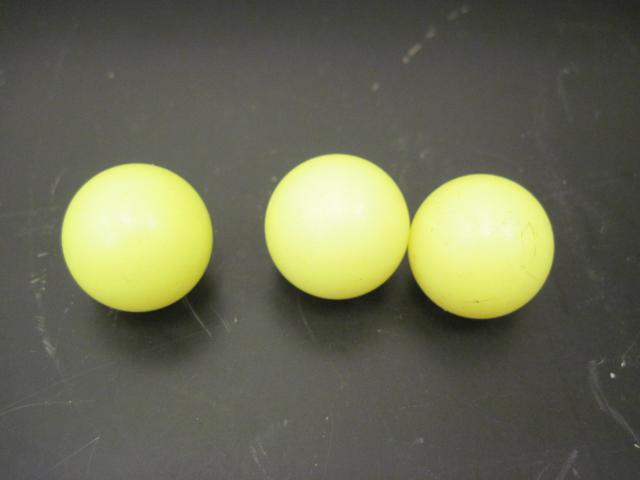 Three yellow plastic balls