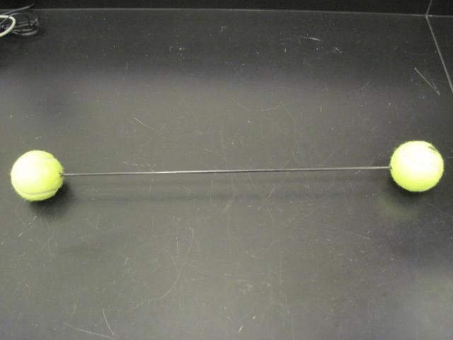Center of mass balls on a tube (tennis ball and weighted tennis ball)