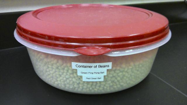 Large plastic dish with lid full of beans for buoyancy demo