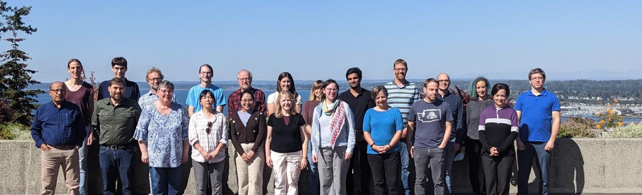 Physics Department Faculty and Staff posing in front of Bellingham Bay