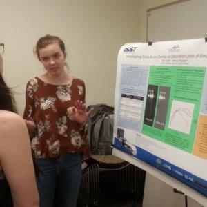 Two students discussing a scientific poster